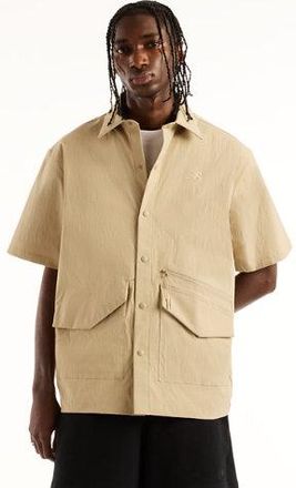 New Balance Hombre NBX Shifted Short Sleeve Shirt en Gris, Nylon tejido, Talla 2XL