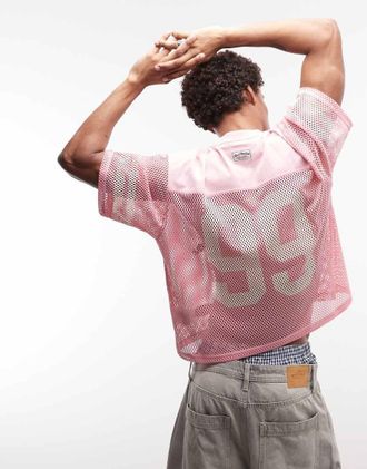 Aape By A Bathing Ape Aape by A Bathing Ape top in jersey a rete oversize rosa con stampe logo multiple