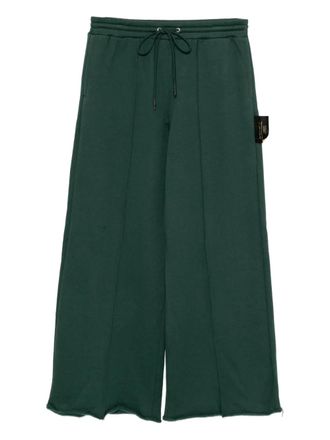 Undercover slogan-patch trousers - Green