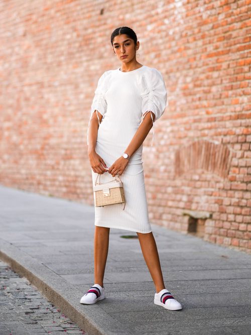 woman wearing white sneakers and white t-shirt midi dress