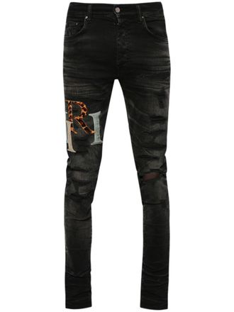 Amiri logo-patch distressed skinny jeans - men - Cotton - 34 - Black