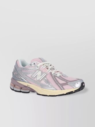 New Balance low top sneakers with mesh upper and rubber outsole