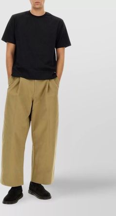 STUDIO NICHOLSON pleated trousers featuring pockets