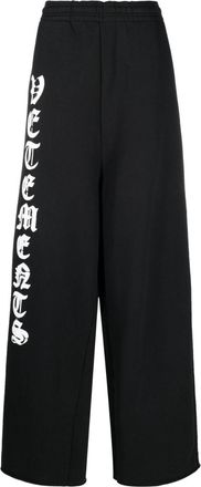 VETEMENTS logo-print wide-leg track pants - men - Polyester - M - Black