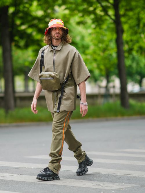 man walking in khaki pants and shirt