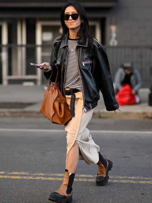 Guest wears a striped shirt with leather jacket and maxi skirt