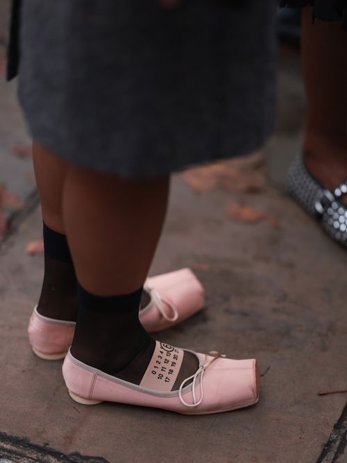 Fashion Week Guest was seen wearing rose maison margiela ballerinas and black socks before ERDEM Fashion Show during London Fashion Week September 2023 at the on September 17, 2023 in London, England.