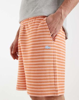 Lacoste Pantaloncini arancioni con righe a contrasto-Arancione