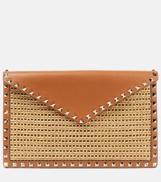 Valentino Garavani Rockstud Large leather-trimmed raffia clutch