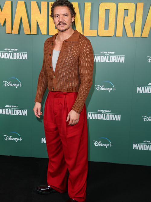 At the premiere of The Mandalorian in London, Pedro wore a brown crochet jacket, a grey singlet, baggy red slacks, and black patent derbys.