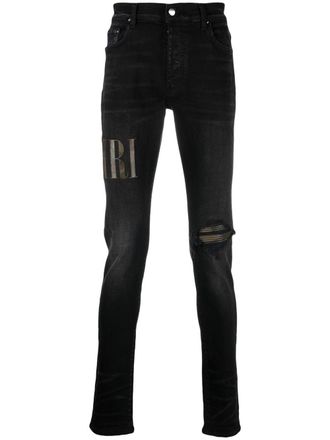 Amiri logo-appliqu&eacute; distressed jeans - men - Cotton/Polyester/Spandex/Elastane/Lamb Skin - 38 - Black