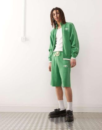 Aape By A Bathing Ape AAPE By A Bathing Ape - Pantaloncini ampi in maglia verde con logo stile college in coordinato