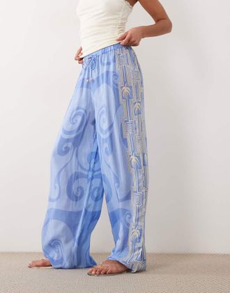 River Island La Mer - Pantaloni da mare blu con stampa di palme