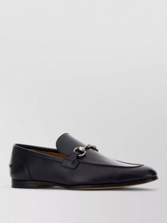 Gucci leather loafers featuring metal buckle detail