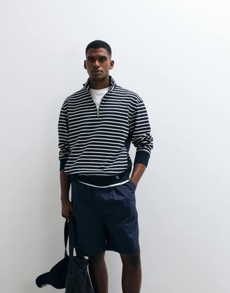 Calvin Klein Jeans Top blu scuro e bianco a righe con zip corta e monogramma a righe