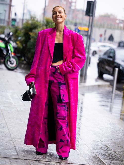 woman wearing long pink coat and pink cargo pants