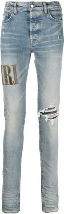 Amiri logo-embroidered ripped-detail jeans - men - Cotton/Elastane - 38 - Blue
