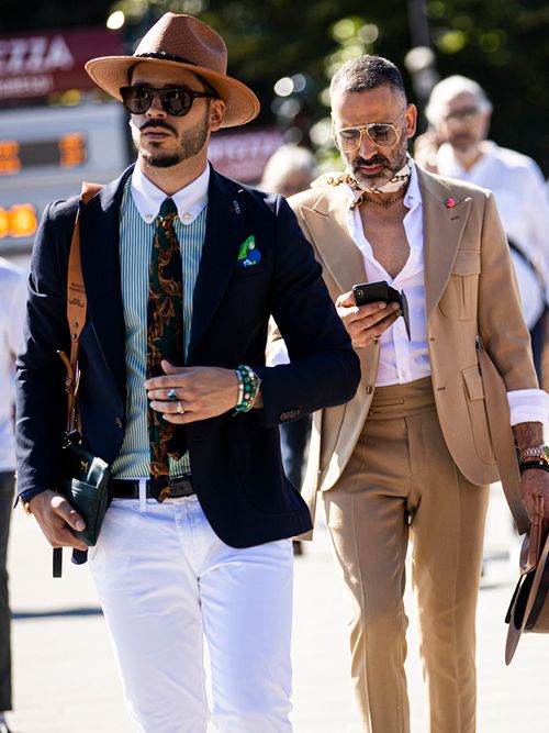 Gentlemen, wearing suits and hats, are seen during Pitti Immagine Uomo 96 on June 13, 2019 in Florence, Italy.