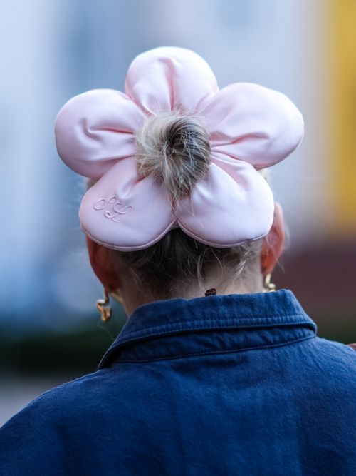 Close-up detail view of a pink oversized hair scrunchie in flower shape, outside Herskind, during the Copenhagen Fashion Week AW24 on January 31, 2024 in Copenhagen, Denmark.