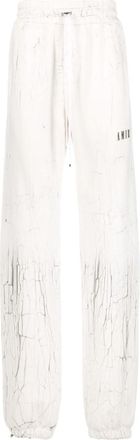 Amiri cracked-print track pants - men - Cotton/Lyocell - XXXL - White