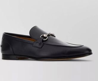 Gucci leather loafers featuring metal buckle detail