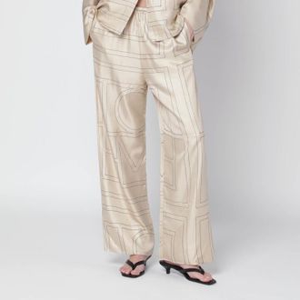 Toteme Ivory silk trousers with monogram