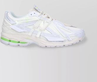 New Balance low top sneakers with mesh panels and reflective accents