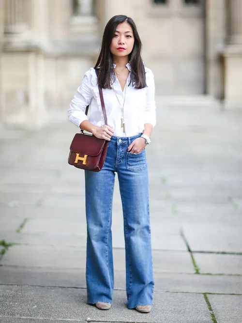 Streetstyle mit weißer Bluse, Jeans und Hermes Tasche.