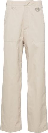 Fendi logo-plaque straight-leg trousers - men - Polyamide/Cotton - 50 - Neutrals