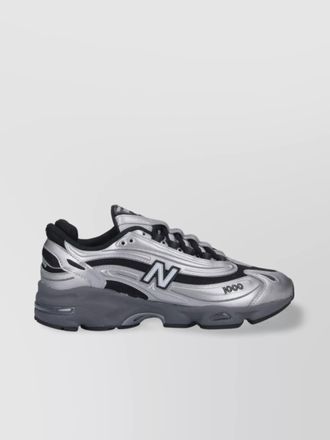 New Balance low top sneakers with mesh panels and reflective accents