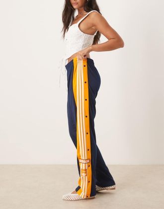 adidas Originals Adibreak - Pantaloni sportivi blu navy e arancioni