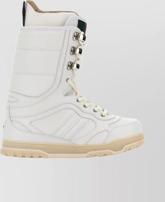 Gucci high-top leather boots featuring metal eyelets