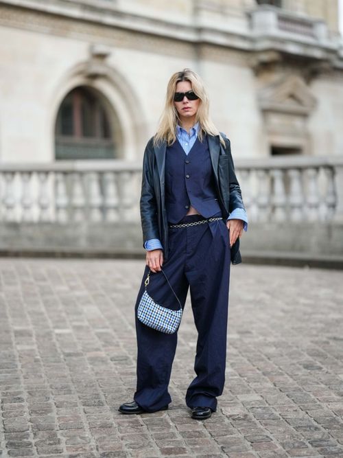woman wearing navy blue suit vest and pants