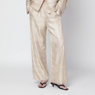 Toteme Ivory silk trousers with monogram
