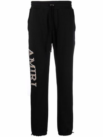Amiri logo print track pants - men - Cotton - S - Black