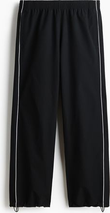 H&M Track Pants mit Print in Relaxed Fit - Schwarz
