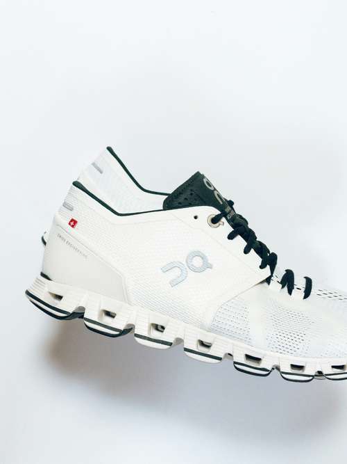 A pair of white On Running sneakers