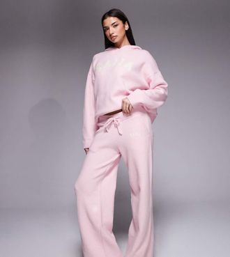 KAIIA Pantaloni a fondo ampio rosa in maglia con logo ricamato in coordinato