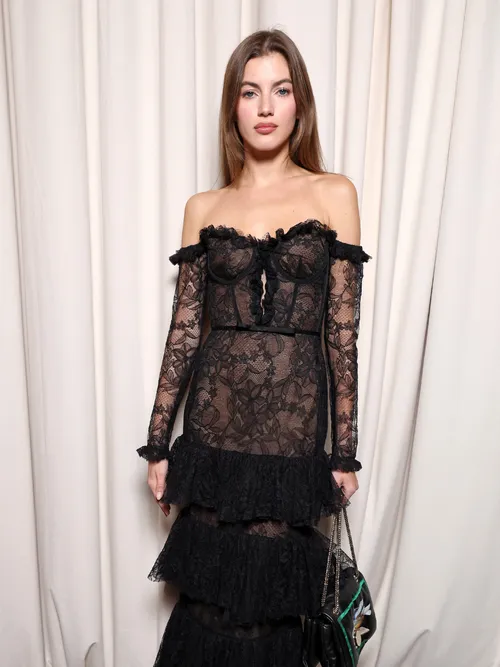 Valery Kaufman wears a black, lace dress with corset details