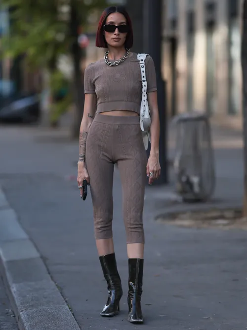 Alexandra Guerain is seen wearing black sunnies, heavy silver chain necklace, brown cotton set in brown, Balenciaga Le Cagole shoulder bag in white and Maison Margiela Tabi boots in black leather outside Marine Serre show during the Menswear Spring/Summer 2024 Fashion Week in Paris, France on June 24th, 2023.