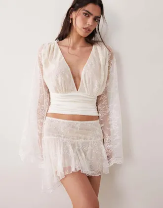 I.AM.GIA Stevie - Minigonna bianca in pizzo con vita scesa e volant asimmetrica in coordinato-Bianco
