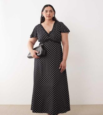 Nobody's Child Vestito midi nero a pois con scollo a V e finiture in pizzo aperto sul retro