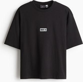 H&M Bedrucktes T-Shirt in Oversized Fit - Schwarz/Rocky