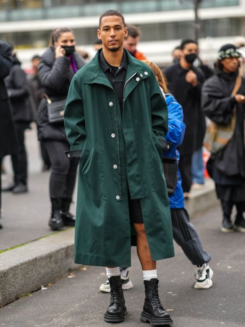 Guest wears a green coat with black leather boots