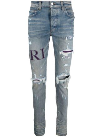 Amiri ripped-knee logo-print skinny jeans - Blue