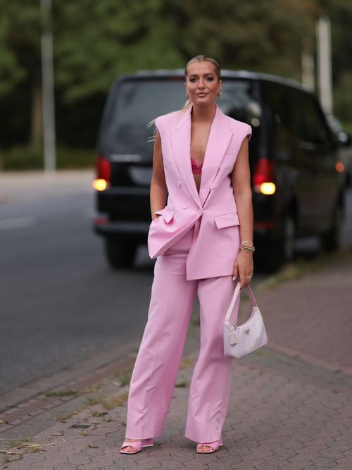 A guest wears a pink blazer vest with matching pants