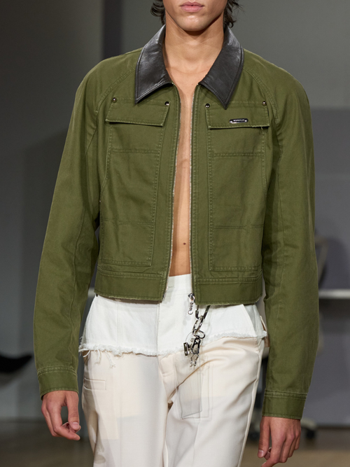A guest wears a cropped green military jacket
