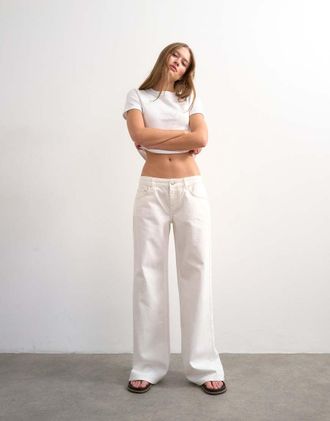 Topshop Jeans a vita bassa con fondo ampio bianco osso