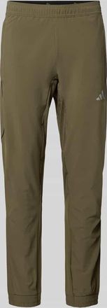 adidas Regular Fit Sweatpants mit elastischem Bund mit Logo-Print Modell TECH APP S-PANT in Oliv, Gr&ouml;&szlig;e XXL