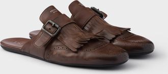 Prada Shuffle antiqued leather mules with buckled strap and fringe